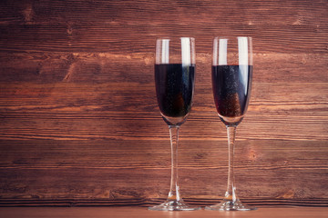 Two glasses with wine over vintage wooden background