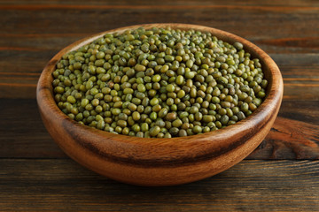 Mung bean in a wooden bowl on wood closeup