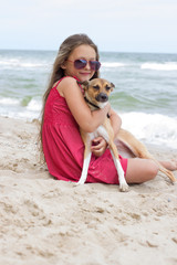 Fototapeta na wymiar child and dog on the beach