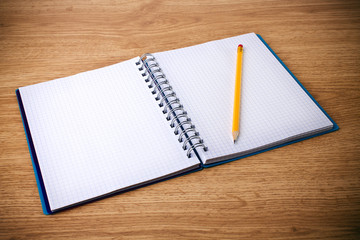 recycle notebook and wooden pencil on wood background