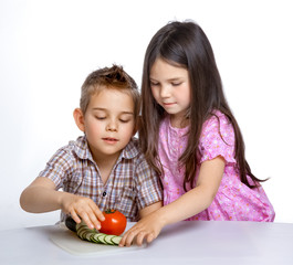 Fototapeta premium Beautiful little childl with vegetable