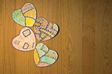 colored paper hearts on  wooden table