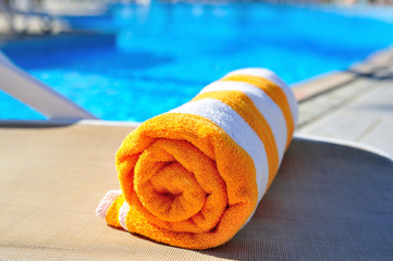 bright beach towel on the background of the pool