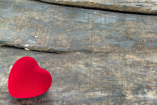 Red Valentine heart on old rustic wooden background