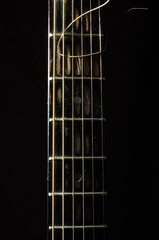 Acoustic 6 string guitar fretboard isolated on the black