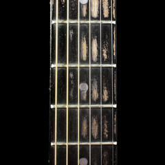Acoustic guitar fretboard isolated on the black background