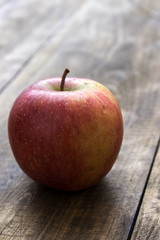Red fresh organic apple on  old wooden table