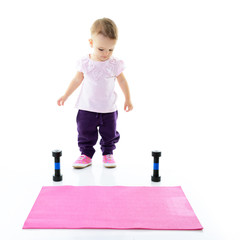 Little fitness girl, studio shot over white background