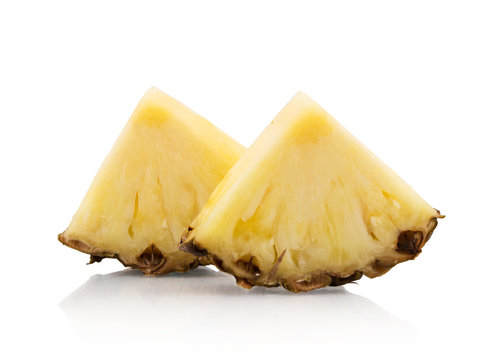 Two pineapple slices on white background