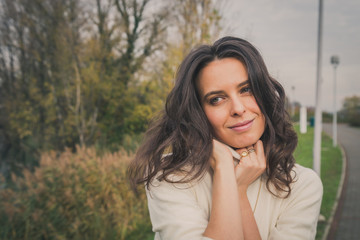 Beautiful young woman posing in a city park