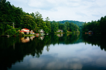 Trees and houses reflecting in Lake Sequoyah, Highlands, North C