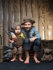 Bully boy in a cap sits near a girl hooligan near the wooden box