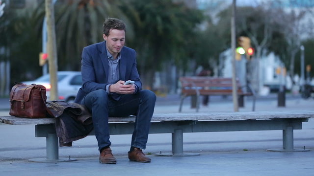Smart phone man talking and texting in city night