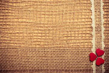 Red hearts on abstract cloth background
