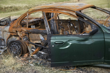 Green car destroyed by fire