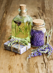 massage oil, herbal soap and bath salt with fresh lavender flowe