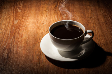 Still-life with a cup of black coffee and roasted coffee beans