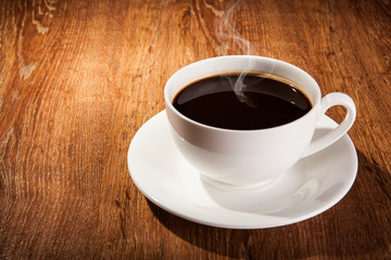 Still-life with a cup of black coffee and roasted coffee beans