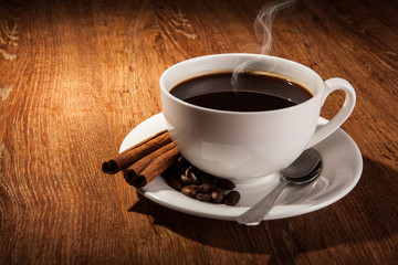 Still-life with a cup of black coffee and roasted coffee beans