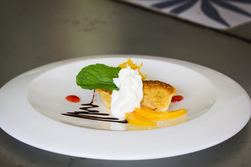 Almond cupcake with whipped cream on white plate