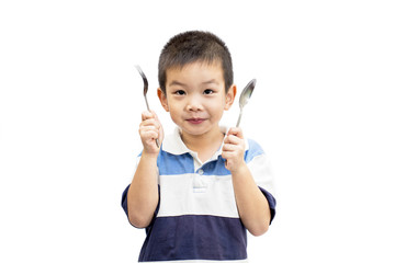 Little handsome Asian boy portrait holding spoon and fork with smiling face isolated on white background