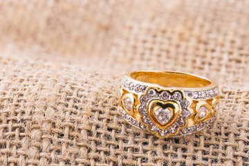 Heart shape diamond ring on burlap hessian sacking texture