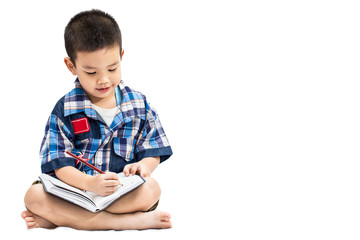 Little asian boy writing book isolated on white background