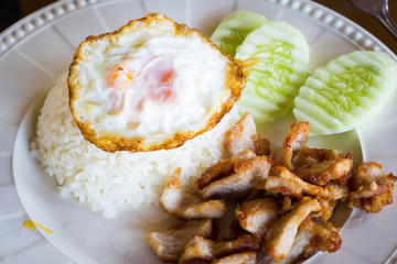 Fried pork garlic with fried egg on rice, Thai food style