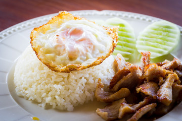 Fried pork garlic with fried egg on rice, Thai food style