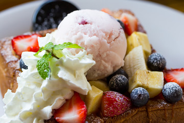 Honey toast with whipped cream,icecream and mix berry