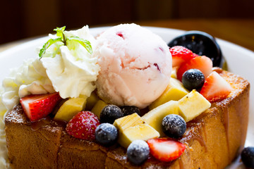 Honey toast with whipped cream,icecream and mix berry
