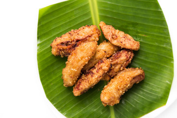 Banana fritters or fried banana served on banana leaf