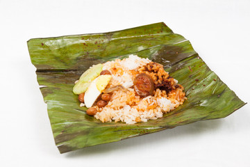 Authentic Nasi Lemak wrapped in banana leaf.
