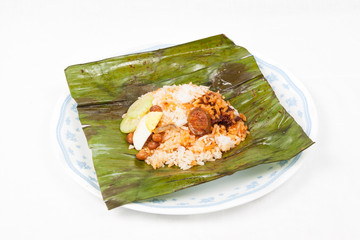 Authentic Nasi Lemak wrapped in banana leaf.