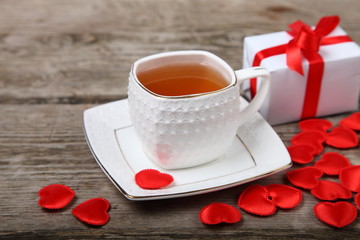 Cup of tea, gift and red hearts