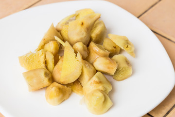 Cut and peeled ginger on plate
