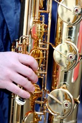 Fototapeta premium Young's hand playing with sounds experienced saxophone