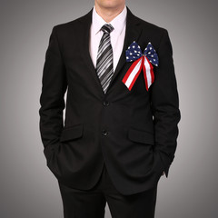 Businessman with American Flag Bow over gray