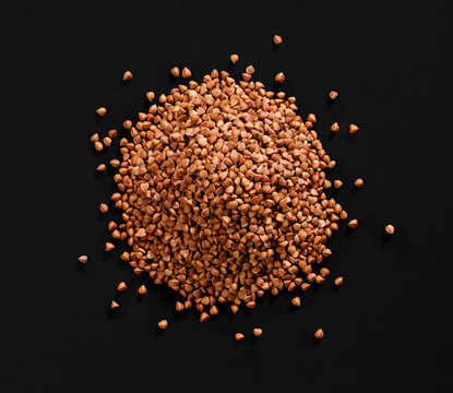 Top view of buckwheat pile premium buckwheat groats on black