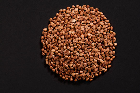 Circle shape made of premium buckwheat groats on black