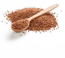 Uncooked buckwheat on wooden spoon