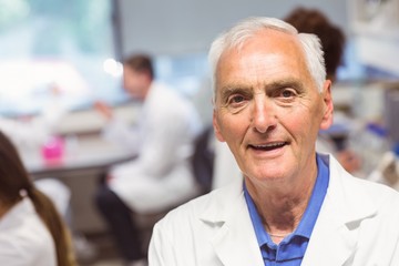 Science lecturer smiling at camera