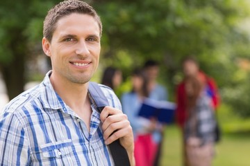 Happy student smiling at camera outside on campus