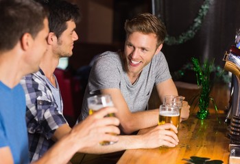 Happy friends catching up over pints