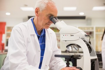 Medical professor working with microscope