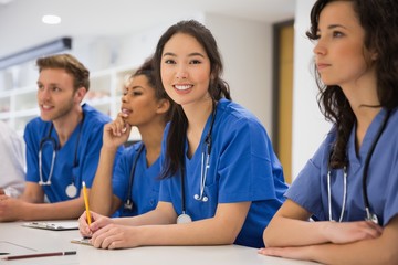 Medical student smiling at the camera during class