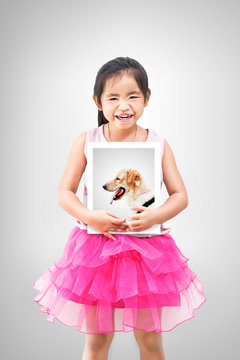 Love pet concept.Little girl holding a picture of her dog