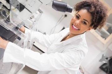 Pretty science student using microscope