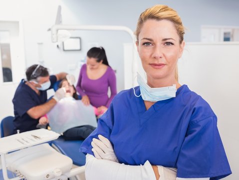 Dentist with folded arms