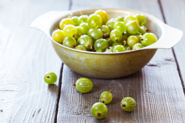 Green gooseberries in a aluminum bowl